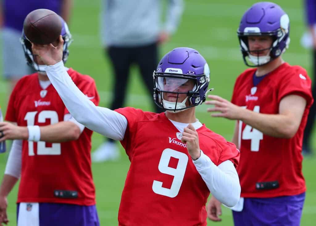 EAGAN, MINNESOTA - JUNE 04: Quarterbacks J.J. McCarthy #9, Sam Darnold #14 and Nick Mullens #12 of the Minnesota Vikings watch the drill during Minnesota Vikings mandatory minicamp at Twin Cities Orthopedics Performance Center on June 04, 2024 in Eagan, Minnesota