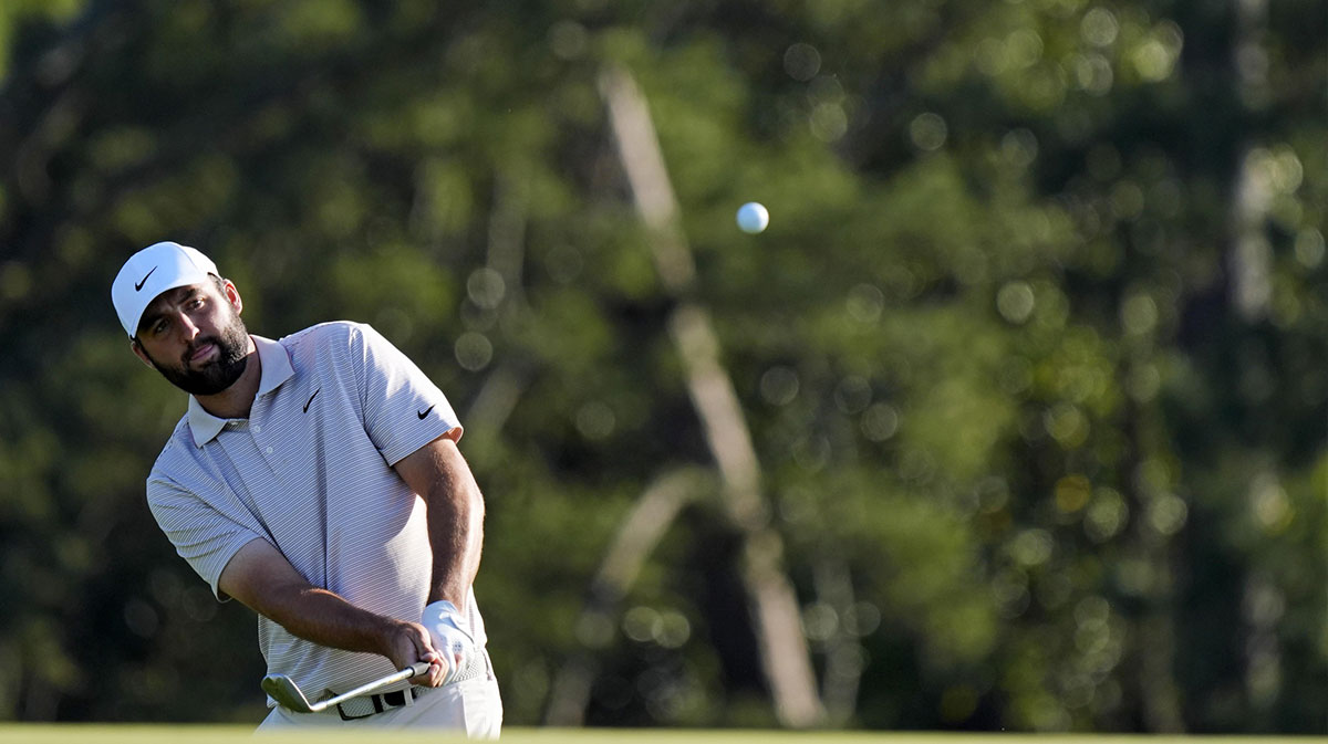 Scottie Scheffler plays from the fairway on the 18th green during the final round of the Masters Tournament at Augusta National Golf Club.