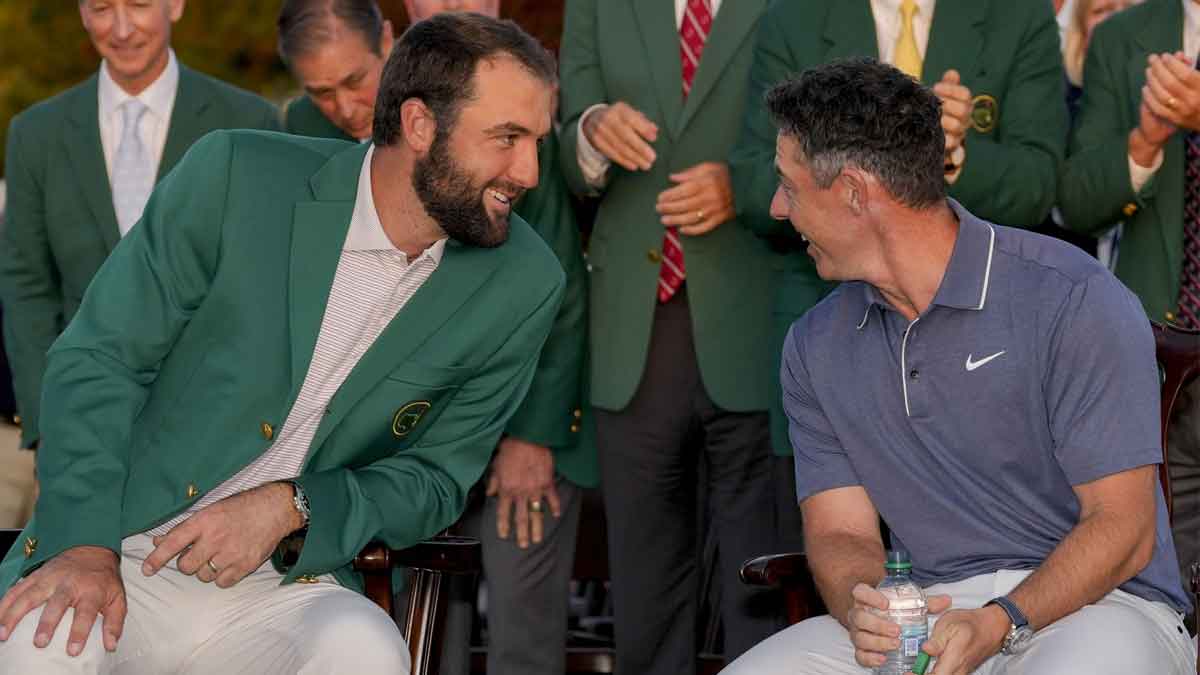 Scottie Scheffler leans over to talk with Rory McIlroy at the green jacket ceremony during the final round of the Masters Tournament at Augusta National Golf Club.